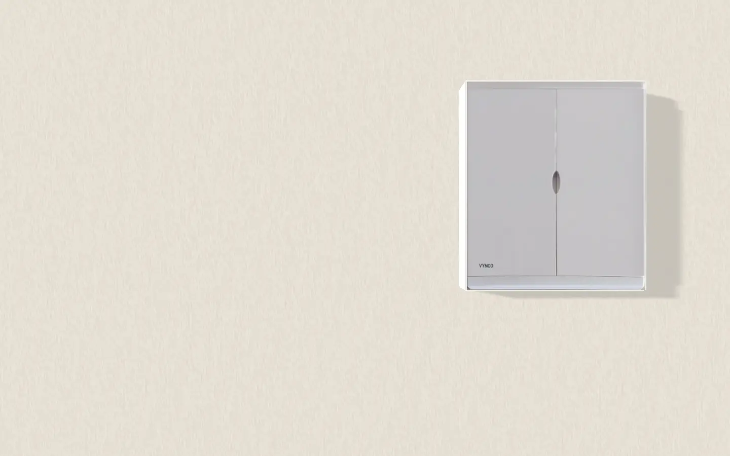 A twin-door VYNCO switchboard on a plastered wall, doors closed